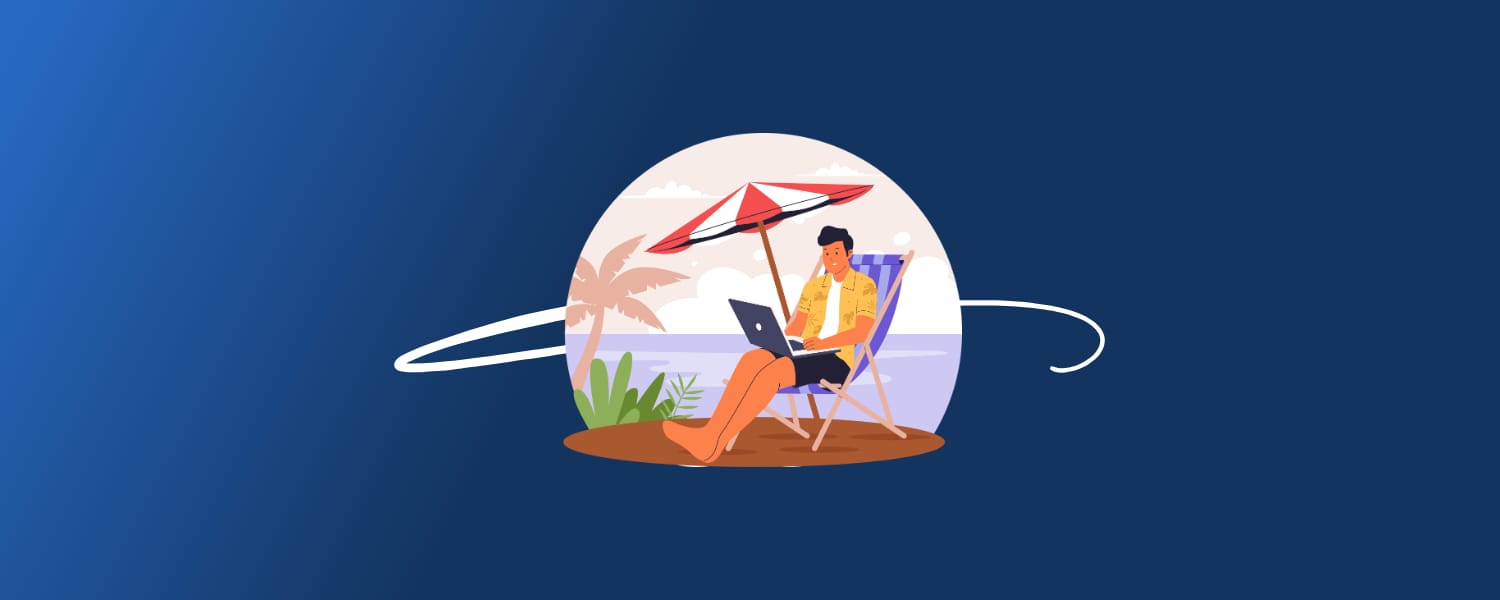 Freelancer working on a laptop under a beach umbrella